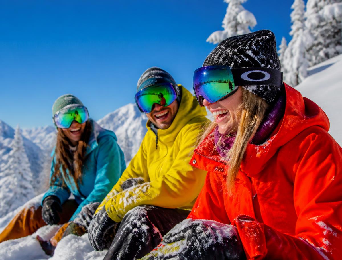 Friends laughing on a bluebird ski day